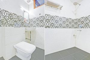 a bathroom with a toilet and a sink at Super Hotel O Gurgaon Old Town in Gurgaon