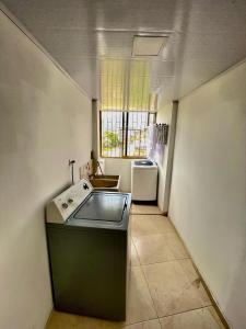 a small kitchen with a sink and a window at Acogedor apartamento en Pereira in Pereira