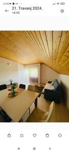 a living room with a table and a couch at Villa Ruscello in Grabovac