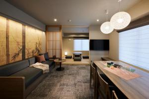 a living room with a couch and a table at Minn Gion Sanjo in Kyoto