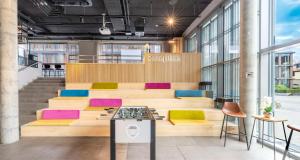 a seating area in a building with colorful cushions at Aiden by Best Western Biberach in Biberach an der Riß