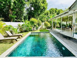 a swimming pool in the backyard of a house at The Good Life - Eco Lodges & Serenity Boutique Hotel - Adults Only in Cap Malheureux