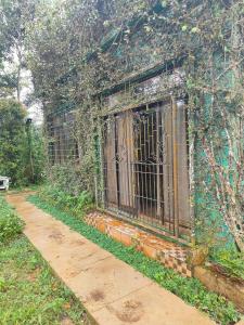 a window with bars on the side of a building at Monte Cristo Summit Home in Sampong