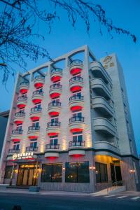 ein großes Gebäude mit roten und weißen Balkonen darauf in der Unterkunft Jin Pin Hotel in Magong