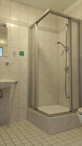 a bathroom with a shower and a toilet at Hotel Zum Rebstock in Malterdingen +86 photos