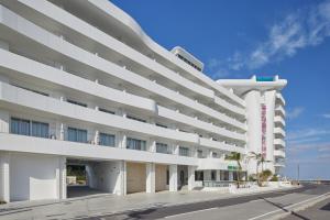 an external view of a large white building at THE SENAGAJIMA STORYLINE in Tomigusuku
