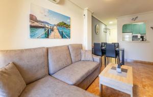 a living room with a couch and a table at Gorgeous Apartment In Torrevieja in Torrevieja