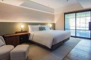 Ένα ή περισσότερα κρεβάτια σε δωμάτιο στο Kilin Hotel, JiaoXi