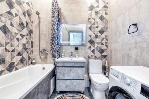 a bathroom with a tub and a toilet and a sink at Уютная квартира на Левом берегу, ТРЦ Хан Шатыр in Astana +5 photos