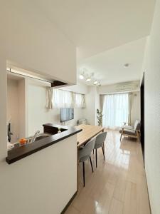 a kitchen and living room with a table and chairs at Sun Court Heiwa-dori 801 in Tsukisappu +33 photos