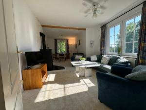 a living room with a couch and a table at Large Swedish Countryside Villa with Garden & Nature Views In Kalmar in Abbetorp