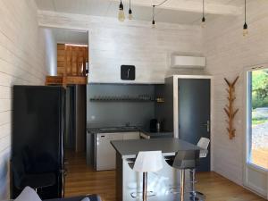 eine Küche mit Tisch und Stühlen in einem Zimmer in der Unterkunft Gite en plein coeur de la Lozère Chalet 2 in Banassac