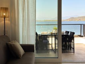 a living room with a view of the water at Aquavista Residence - Pied dans l'eau & Pool in Castelletto sopra Ticino