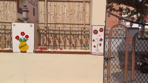 a fence with a gate with a vase of flowers at V Food Dormitory in Jodhpur