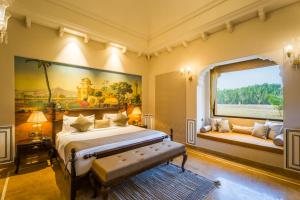 a bedroom with a bed and a large painting on the wall at Gobindgarh Jaisalmer in Jaisalmer +51 photos