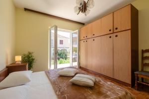 a bedroom with a bed with two pillows on it at Naša kuća in Vela Luka