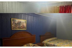 a bedroom with two beds and a painting on the wall at Best Motel By OYO Chicago I-90 in Chicago