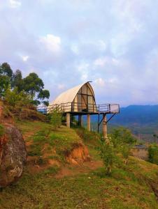 a glass building on top of a hill at Cocoon Creek in Kodaikānāl +37 photos