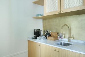 a kitchen with a sink and a counter top at Makom Ferdinand Duval in Paris