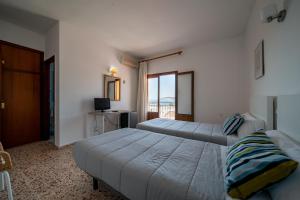 Кровать или кровати в номере Hotel Buigues