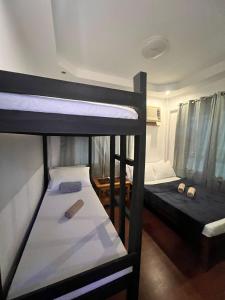 a group of bunk beds in a room at Recuerdo Transient House By LA MAR Hospitality in El Nido
