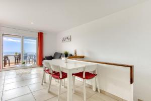 a white dining room with a white table and chairs at Villa Buraux III in Roses +21 photos