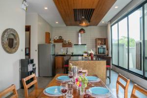 a kitchen and dining room with a table and chairs at Narintara Private Villas - Hotel style service with Free Tuk Tuk to the beach in Ao Nang Beach