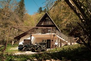 a house with two atvs parked outside of it at Villa Planica Holiday Home in Kupa