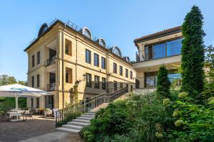 a large brick building with a staircase in front of it at Artsy Exclusive Old Town Residence Gallery Walk in Vilnius