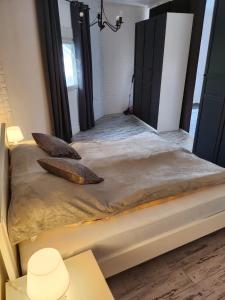 a bed with two pillows on it in a room at Spa Apartment Family Belgrad in Brestovik +19 photos