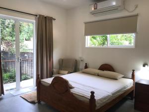 Postel nebo postele na pokoji v ubytování Kandy Brick Bungalow