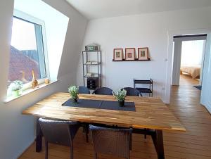 a dining room with a wooden table and chairs at Ferienwohnung Kossinna in Detmold