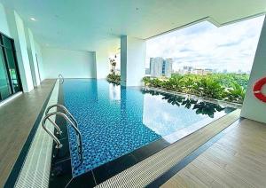 a swimming pool in a building with a view of a city at Edumetro Subang Permai USJ in Subang Jaya