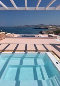 a swimming pool with a view of the water at In Paros, fantastic waterfront villa in Parikia