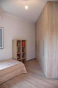 a bedroom with a bed and a wooden cabinet at Garden Villa Patra in Flámbouras