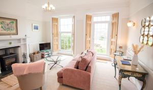 a living room with a couch and a fireplace at Old Vicarage Mortehoe Near Woolacombe 2 x sleeps 4 and 1 x sleeps 10 cottages in Mortehoe