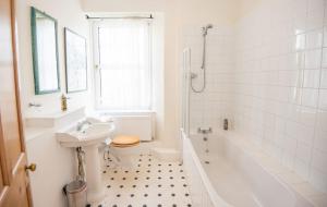 a bathroom with a sink and a toilet and a tub at Old Vicarage Mortehoe Near Woolacombe 2 x sleeps 4 and 1 x sleeps 10 cottages in Mortehoe +34 photos