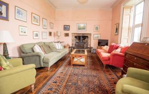 a living room with two couches and a fireplace at Old Vicarage Mortehoe Near Woolacombe 2 x sleeps 4 and 1 x sleeps 10 cottages in Mortehoe