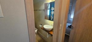 a bathroom with a sink and a toilet and a mirror at Debbies διαμέρισμα δίπλα στο νερό #2 ! in Chalkida +36 photos