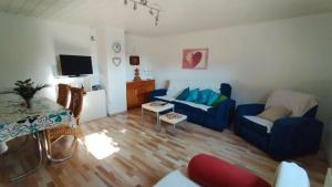 a living room with a blue couch and a table at Ferienwohnung Thielen in Badem