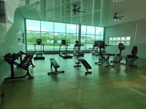 a gym with a bunch of exercise equipment in a room at AZ Mahkota Valley Suites studio in Kuantan