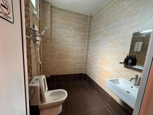 a bathroom with a toilet and a sink at Tropical Villa Kuantan in Kuantan +44 photos