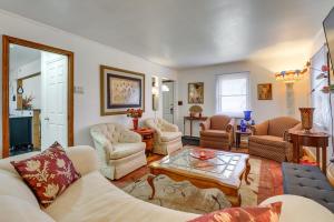 a living room with a couch and chairs and a table at 3 bedroom colonial house in Royal Oak