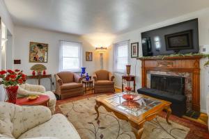 a living room with a fireplace and a table at 3 bedroom colonial house in Royal Oak +8 photos