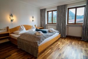 莱赫阿尔贝格Hinterwies – Ski In / Lodge / Dine的一间卧室,配有一张带两个泰迪熊的床
