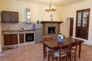 a kitchen with a table and a fireplace at Poggio di Cammilletto in Montefiascone