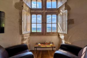 a room with a table and a large window at Chateau de Saint Dau in Figeac