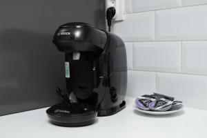 a black coffee maker sitting on a counter at Bastion New Apartment with Parking in Košice