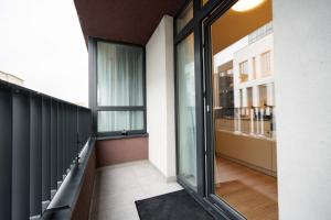 a balcony with sliding glass doors and a view of a building at Bastion New Apartment with Parking in Košice