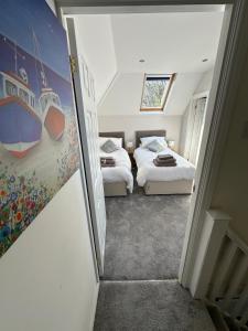 a small bedroom with two beds and a window at Luxury, Tranquillity Near Beach in Carbis Bay +19 photos